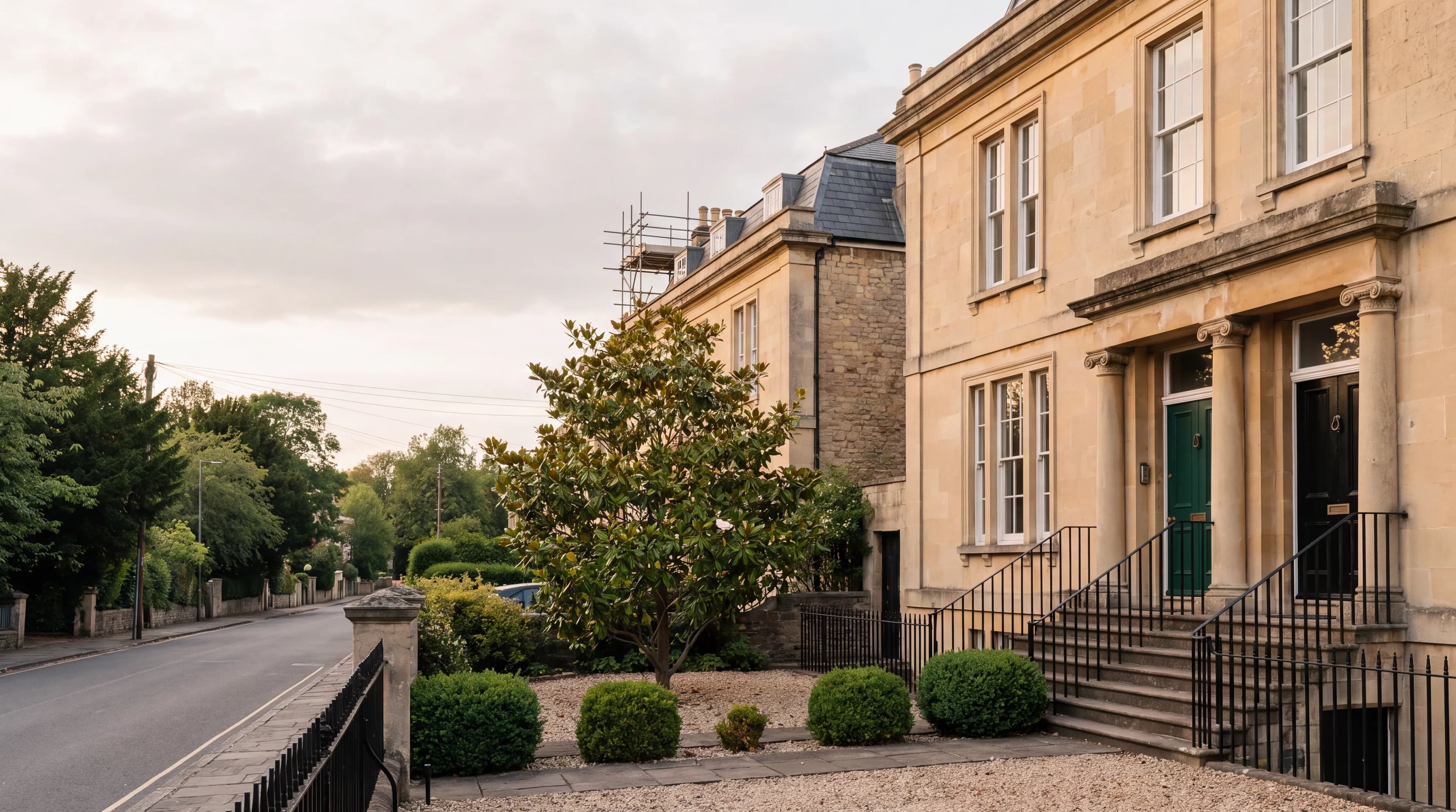 A pair of adjoining Bath-stone Victorian villas in Clifton, Bristol, one with scaffolding to the rear.